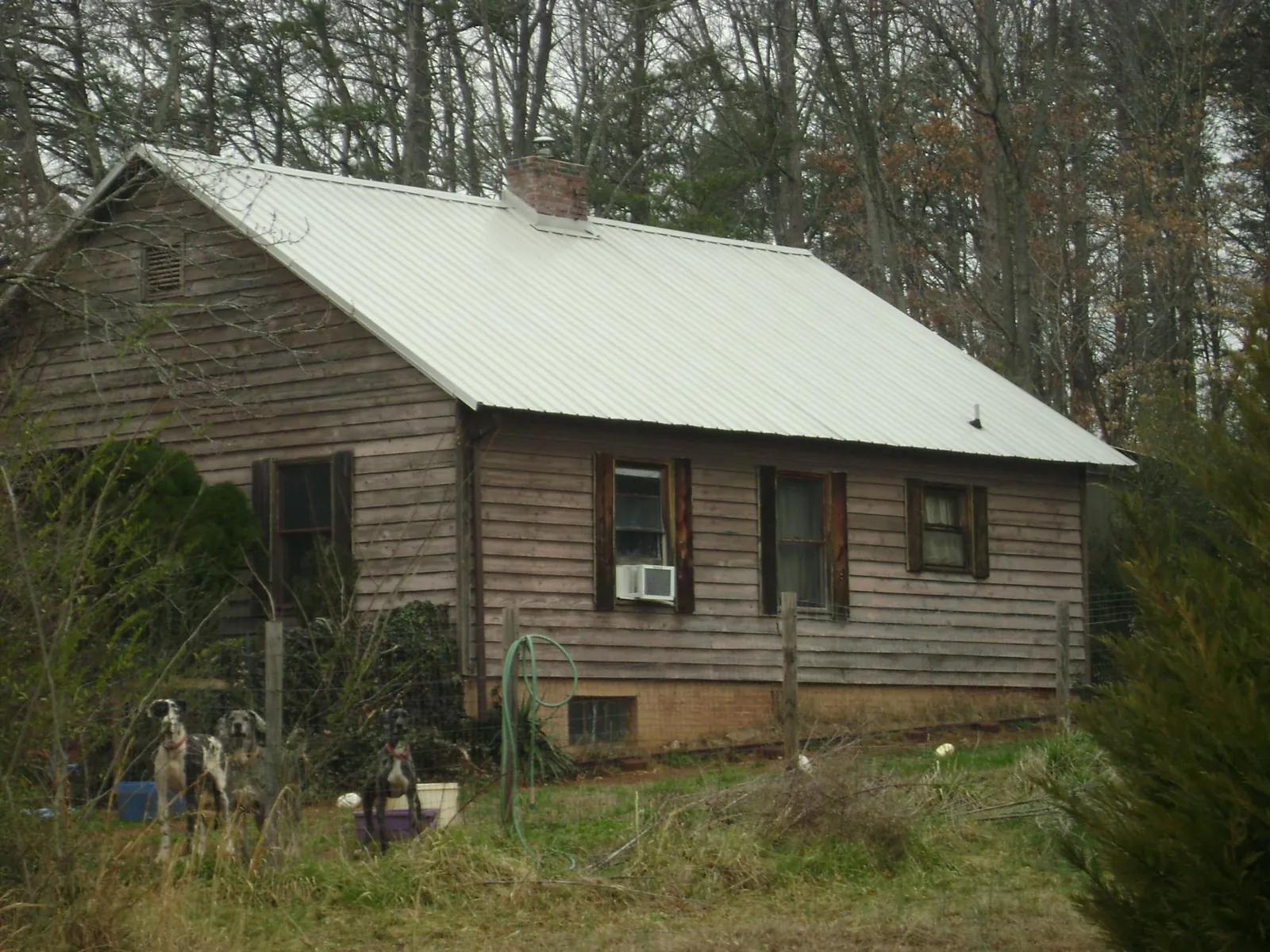 White metal roof on an old wood sided farmhouse, from a Metal Roof Installation job in Chesterfield